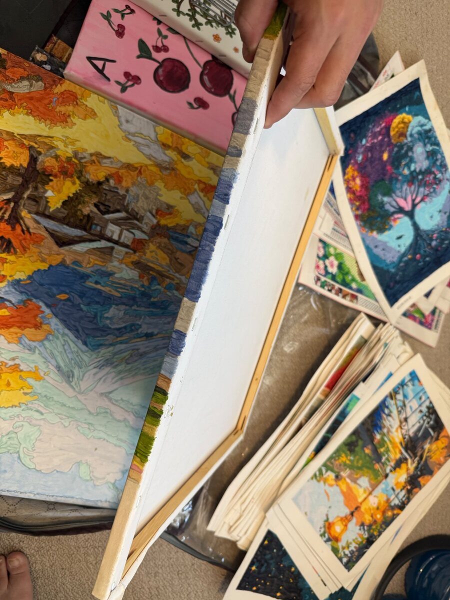 A stack of Melissa's finished canvases